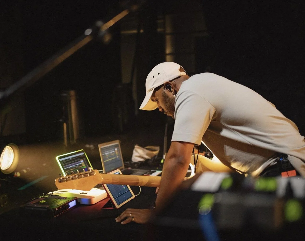 Lawrence Carroll IV working with audio equipment and a guitar